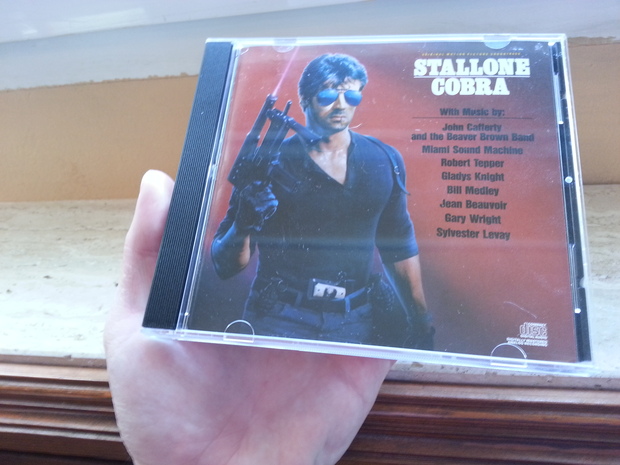 CD Banda Sonora de la película de Cobra Protagonizada por Sylvester Stallone del año 1986 Edición Estadounidense