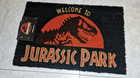 Bienvenidos a Jurassic Park. Felpudo. Mi Compra 13-09-2026. Bienvenidos-a-jurassic-park-felpudo-c_s